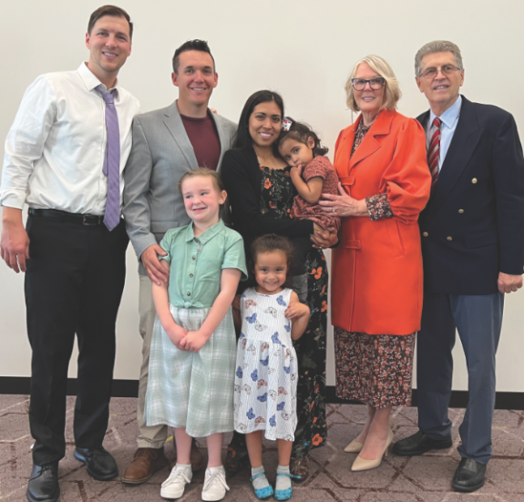 Filip (far left) and Rade (far right) Milosavljevic smile together with Rade’s wife (second from right) and Joshua and Rebecca’s family.