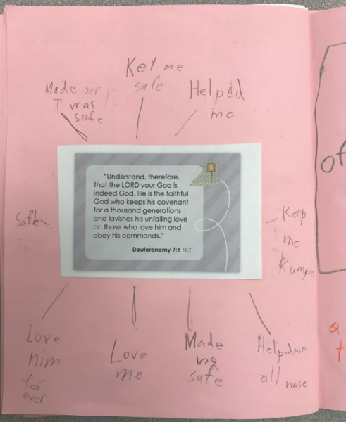 Colin writes notes around a Bible verse lesson in 3rd grade.