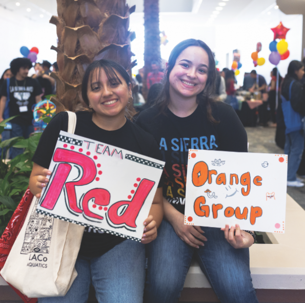 La Sierra University students and campus tour leaders Anett Pajuelo, left, and Paulina Tapia pose during the AVID Day fair.