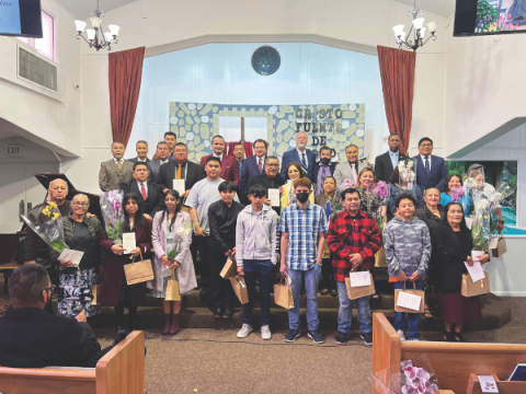 Newly baptized members pose with El Camino a Cristo church leaders and Pacific Union Conference leaders. More than 20 people were baptized as a result of the week-long evangelistic series.