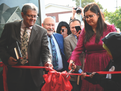 A ribbon-cutting ceremony initiated the church status celebration. Diaz (right) cuts the ribbon as Salazar (left) holds it in place.