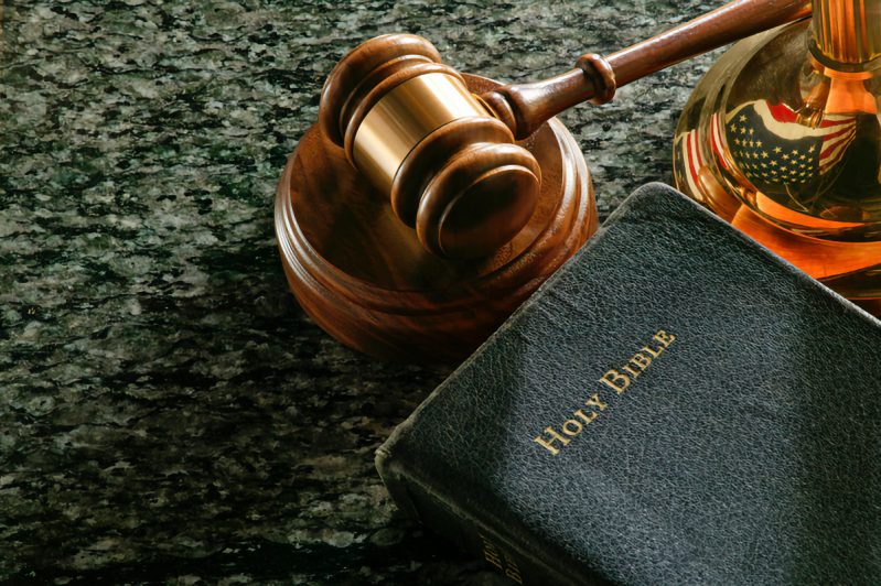 "Close up of gavel, bible,and scale of justice on marble surface. Reflection of American flag in scale of justice.For more legal images click here:"