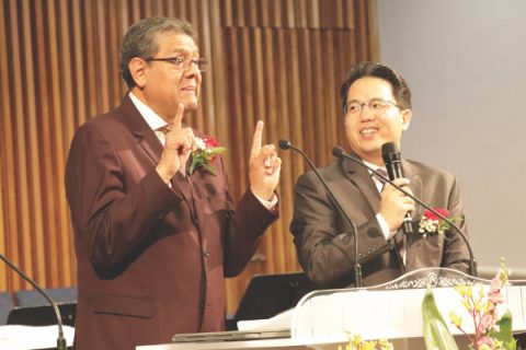 Salazar (left) preaches while Choe (right) translates.