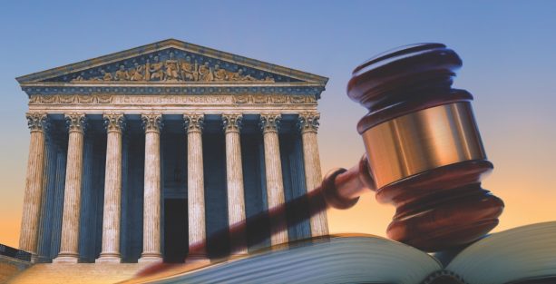 A gavel rests on top of an open law book with the U.S. Supreme Court building in the background.