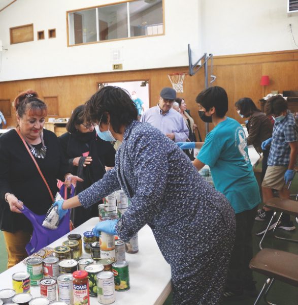 Visitors choose from a variety of items in the food pantry located in Whittier church gym.