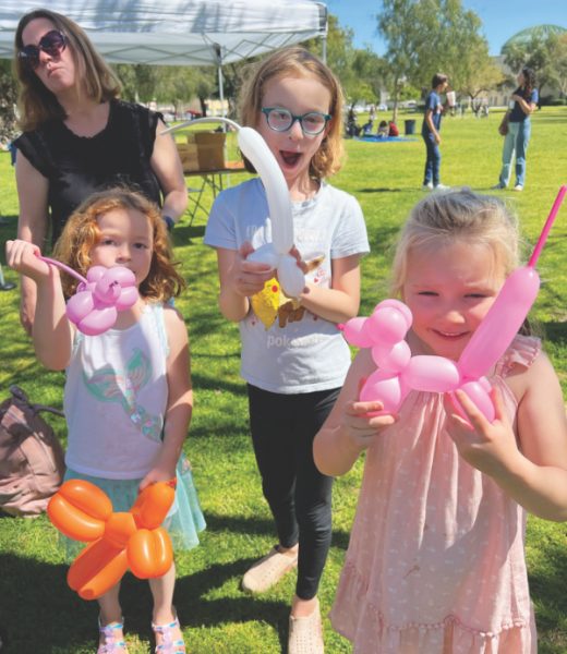 Children admire their balloon animals.