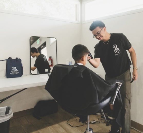 Aaron Amaya finishes a free haircut.