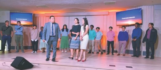 Pastor Dan Hilasaca prays for the team and their leaders, Joelis Colmenarez and Isabel Ingelse