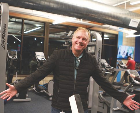 La Sierra University Athletics Director Javier Krumm poses inside the new fitness center during the Nov. 30 grand opening event.