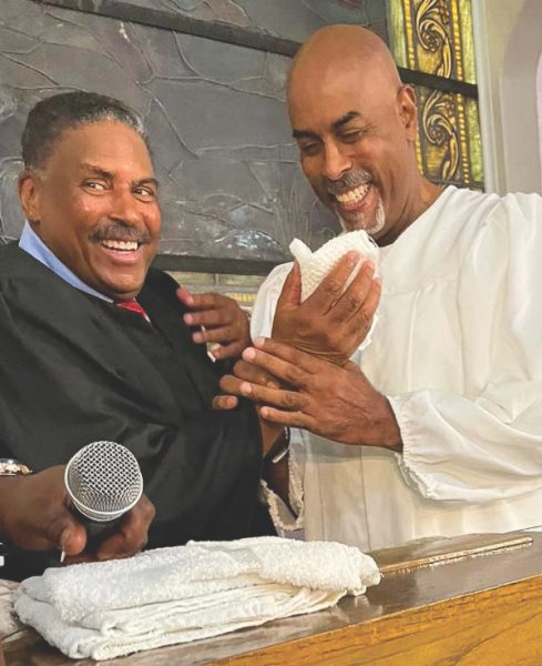 Dorsey (left) prepares to baptize his brother, Brandt (right).