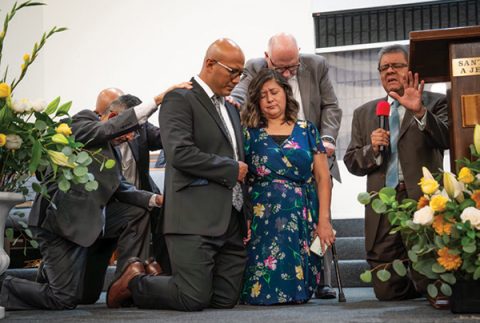 SCC President Velino A. Salazar offers the ordination prayer over Flores and his wife.