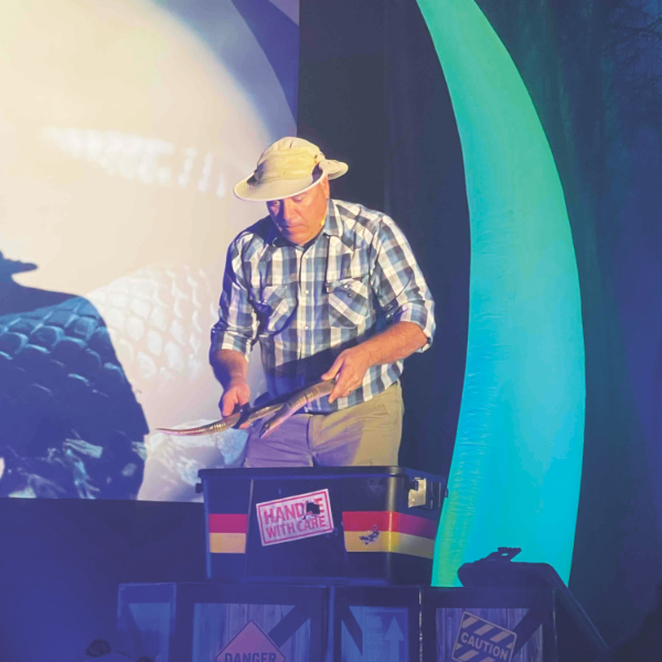 Rich Aguilera shows a rubber snake to prove that dinosaurs are not the only animals people classify as scary.