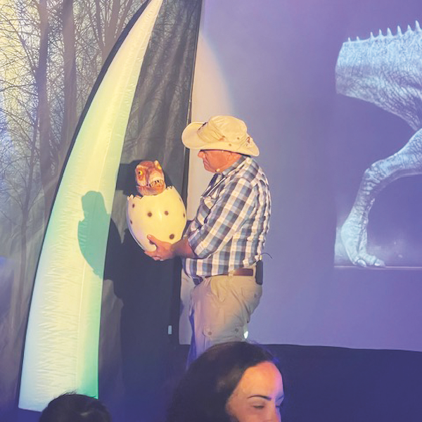 Rich Aguilera introduces his T-Rex puppet named Rexy.