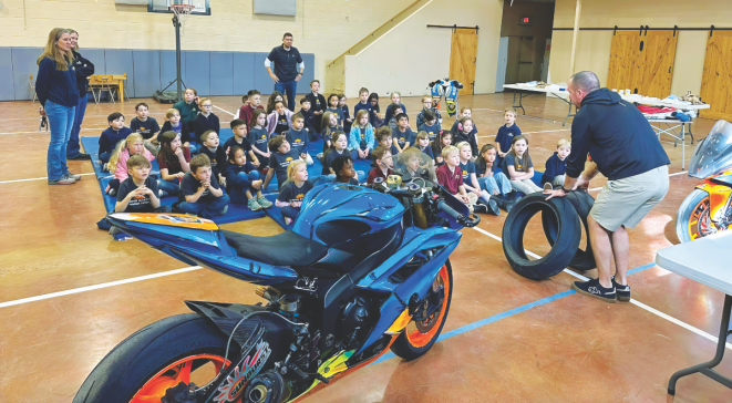 Mr. Charly Mabry, a motocross/motorcycle racer, teaches the students about centripetal force and friction. He also provided several interactive hands-on demonstrations.
