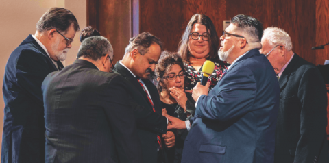 The Nevada-Utah Conference administrators, along with the Carson City church elders, pray over Manny and Marian LaPorte as they start their pastoral ministry. 