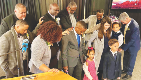 Oneil Madden, Black Ministries director; Chanda Nunes-Henry, executive secretary of the Nevada-Utah Conference; and the elders of the Sparks church pray and lay hands on the Solomons.
