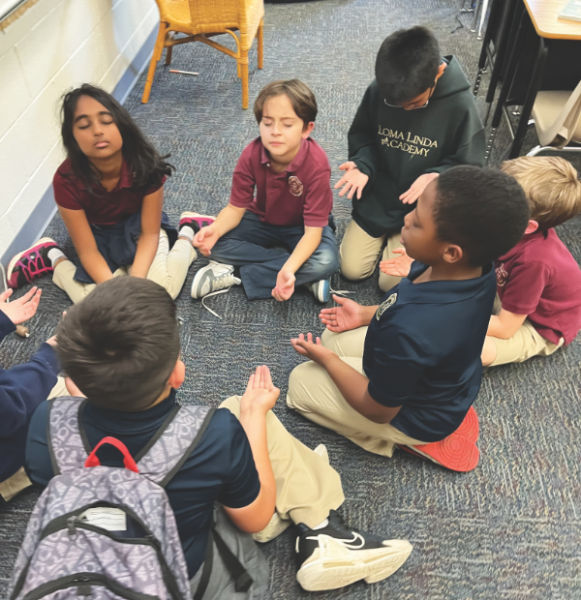 Students pray with the palms up technique.
