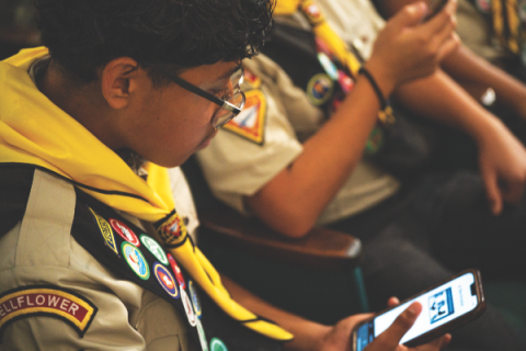 Pathfinders vote via phone for their favorite pins during a presentation on the upcoming International Pathfinder Camporee in Gillette, Wyoming.