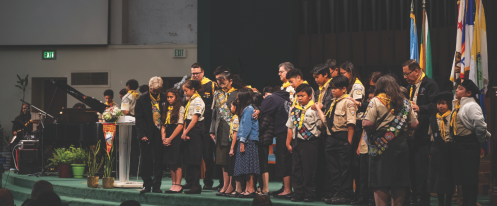 Miranda (back left), alongside Pathfinder leaders and Salazar (back center), prays for Pathfinders’ desire for baptism.