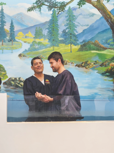 Pastor Jose Jimenez of the Tucson Central Spanish church prepares to baptize one of several attendees to the evangelistic meetings that took place at his church.