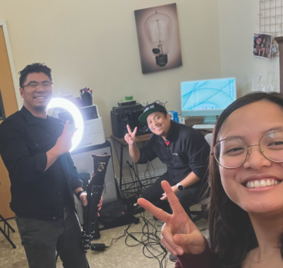 Neil Hernandez (center) works as media producer 
with the co-hosts.