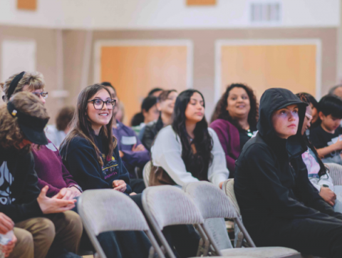 GYD 2024 participants enjoy the short, inspiring message before preparing food to take to the local streets.