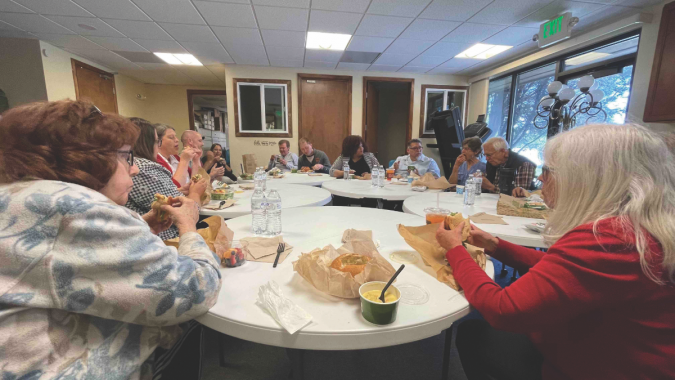 NUC office administration and staff enjoy fellowship with the Wednesday morning prayer group over lunch.