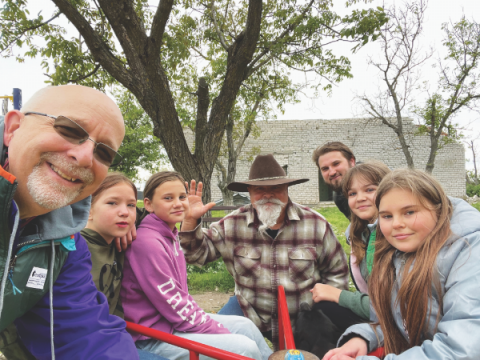 El pastor Paul Blake (izquierda) y el pastor Hugh Barton (centro) pasan con niños ucranianos.