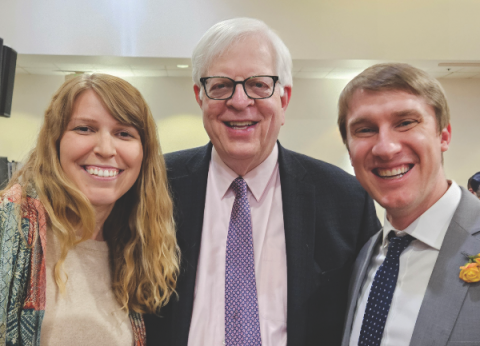 Dennis Prager (center) smiles with two LLUC members.