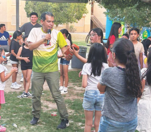 Pastor Antulio Espinoza hands out prizes during the Dia del Niño festival.