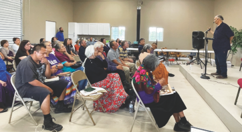 Hermus Poor Thunder (right) shares his testimony with the attendees at the Fluted Rock Camp Meeting.