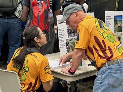 Lily Chairez (left) and Mike Wood in the Arizona Conference cactus honor booth.
