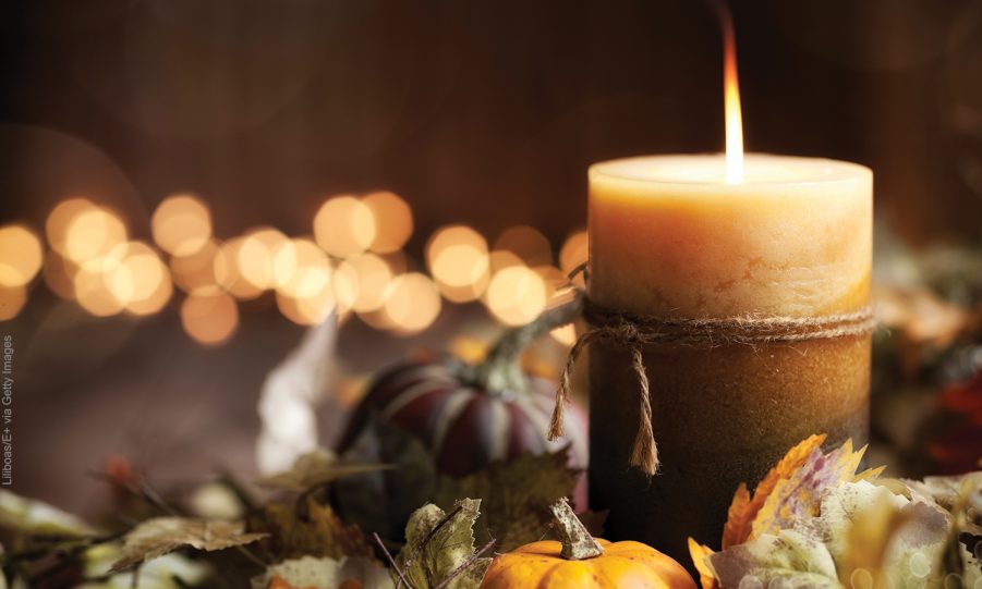 Thanksgiving Autumn Harvest Pumpkin Wreath and Candle on an Old Wood Background