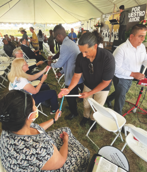 Elders share their flames during the candle ceremony as a symbol of the shared mission of the church.