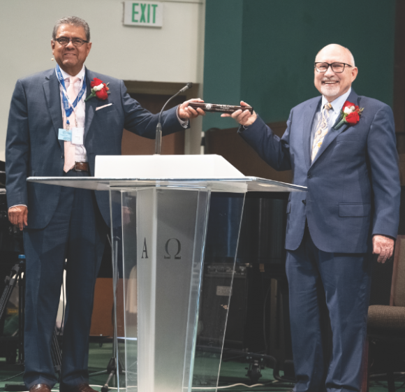 Salazar, retiring SCC president (left), passes the baton to Cress, newly elected SCC president.