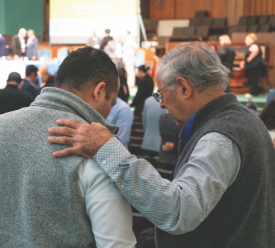 Delegates engage in a season of prayer to conclude the worship portion of the session meeting.