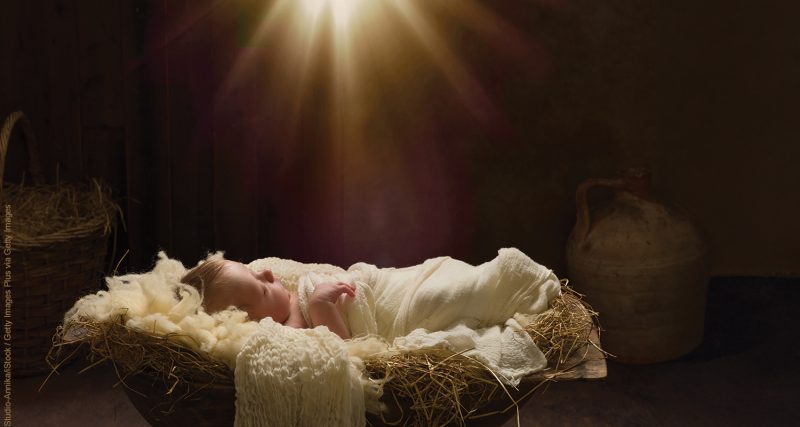 Live Christmas nativity scene of 8 days old baby boy sleeping in a manger