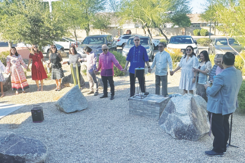 Members of the Chandler Fil-Am church join hands and sing hymns after their mortgage was burned.