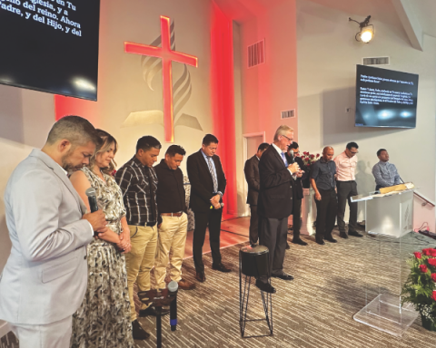 Reggie Leach leads the leadership team at the Phoenix Central Valley Spanish church in a dedicatory prayer at the conclusion of the mortgage burning celebration.