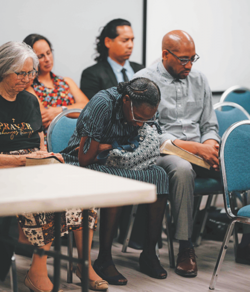 Attendees pray individually in silence.