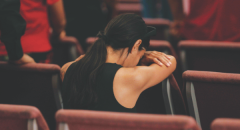 One of the attendees kneels to pray. All preferred postures of prayer were welcomed.