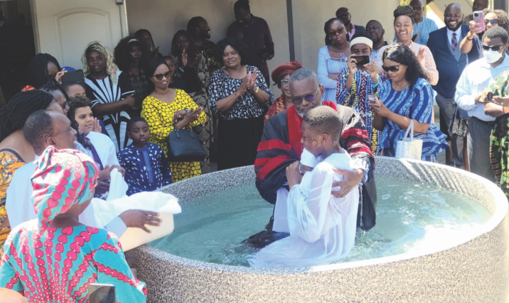 Pastor George Dzimiri baptizes a youth member at All Nations African church.