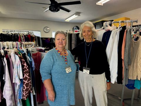 Sharon (left) and Helga (right) work in the Camp Verde Seventh- day Adventist Food Bank’s clothing distribution area.