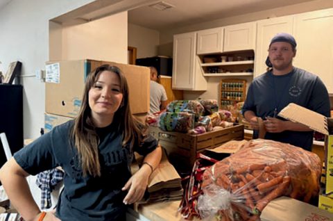 Emory (left) and Michael (right) work to fill boxes of food that are picked up or delivered to community members in the Verde Valley.
