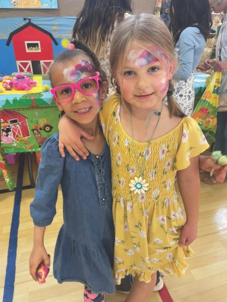 Two happy attendees show off after a visit to the face painting station.