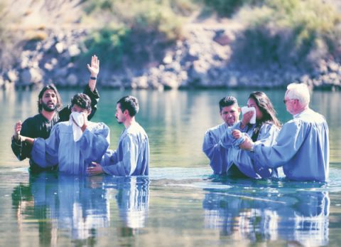 Along with church elders, Riojas baptizes Diego and Kiana Ortiz.