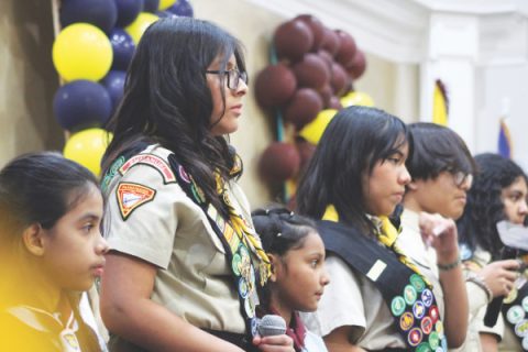 A group of Pathfinders and Adventurers in uniform lead the service with songs.
