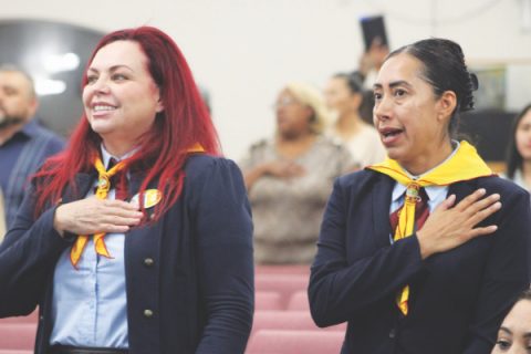 Leaders place their hands over their hearts while singing the Pathfinder song.