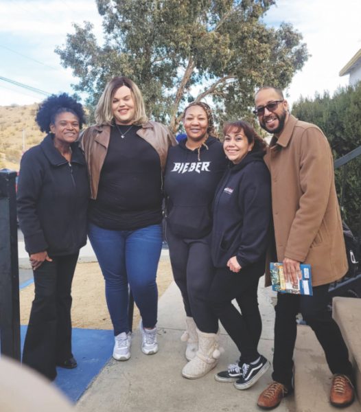Volunteers and Pastor White take a photo during the drive.
