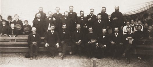 California camp meeting 1880s. Seated, left to right: J.N. Loughborough, Alonzo T. Jones, William C. Grainger, Stephen N. Haskell, C.H. Jones, Ellet J. Waggoner, J.M. Rice.